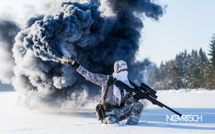 HD desktop wallpaper of a soldier in winter camouflage holding a sniper rifle, crouching by a billowing smoke grenade in a snowy landscape.