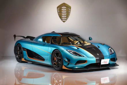 HD desktop wallpaper featuring a stunning blue Koenigsegg Agera supercar, showcasing its sleek design and high-performance build.