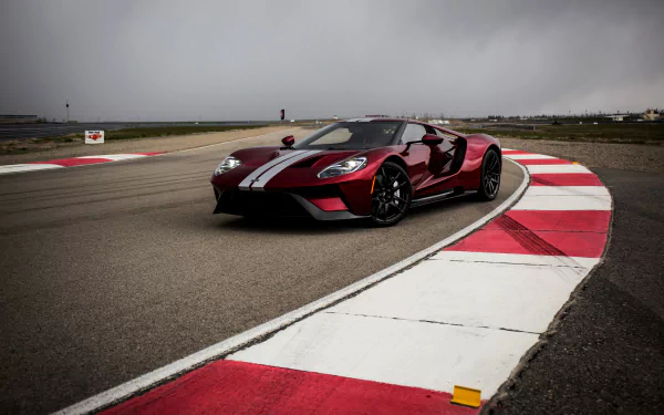 A sleek Ford GT supercar in deep red with white racing stripes speeds around a racetrack under a cloudy sky, captured in stunning 4K Ultra HD quality.