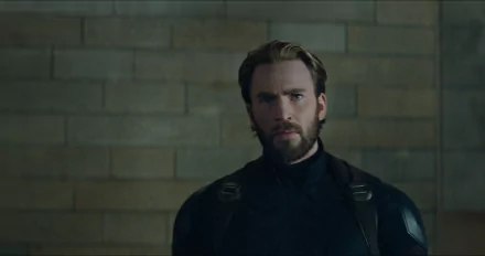 HD wallpaper featuring Chris Evans as Captain America (Steve Rogers) from the movie Avengers: Infinity War. Evans is seen in his superhero costume against a brick wall background.