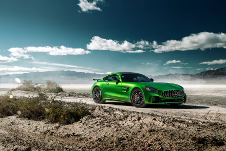 A vibrant green Mercedes-AMG GT supercar parked on a desert landscape under a partly cloudy blue sky, captured in 4K Ultra HD for a PC desktop background.
