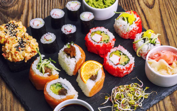 5K Ultra HD PC desktop wallpaper of assorted sushi food: seafood and fish rolls over rice, with wasabi, pickled ginger, soy sauce and sprouts on a slate board.