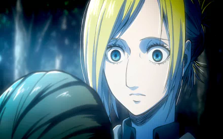 An HD desktop wallpaper featuring Annie Leonhart from Attack on Titan, captured in an intense moment with wide blue eyes, set against a dark forest background.