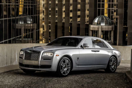 Silver Rolls-Royce Ghost parked in an urban setting, featured as a 4K Ultra HD PC desktop wallpaper and background.