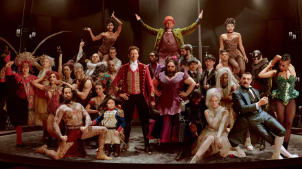 HD wallpaper of 'The Greatest Showman' cast posing in a theatrical setting for a desktop background.