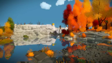HD PC desktop wallpaper/background from the video game The Witness: vibrant orange and red autumn trees and layered limestone cliffs reflected in calm blue water under a clear sky.