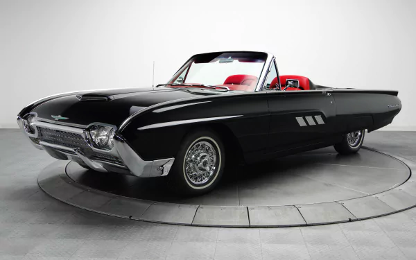 Classic black Ford Thunderbird roadster with red interior on a circular studio turntable — 4K Ultra HD PC desktop wallpaper and background.