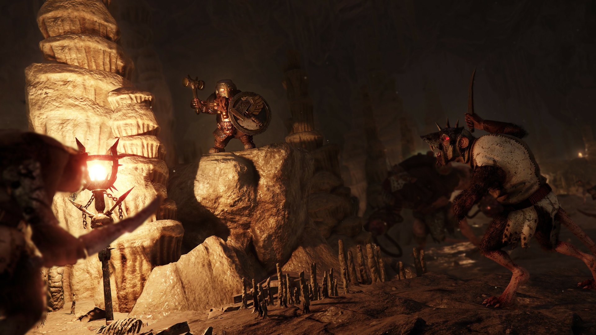4K Ultra HD PC desktop wallpaper from the video game Warhammer: Vermintide 2: torchlit cavern scene with armored heroes facing rat-like Skaven amid stalagmites.