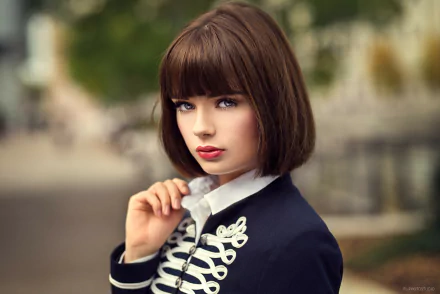 HD desktop wallpaper of Marie Grippon, a brunette model with short hair, blue eyes, and bold lipstick, dressed in a stylish jacket with decorative buttons.