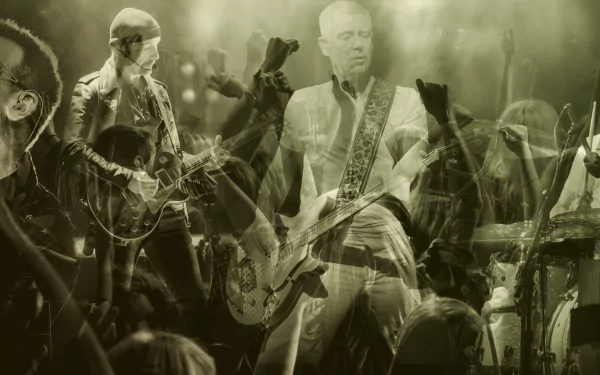 Sepia-toned HD PC desktop wallpaper of a live rock concert: guitarists on stage, bassist center, crowd with raised hands — music-themed background.