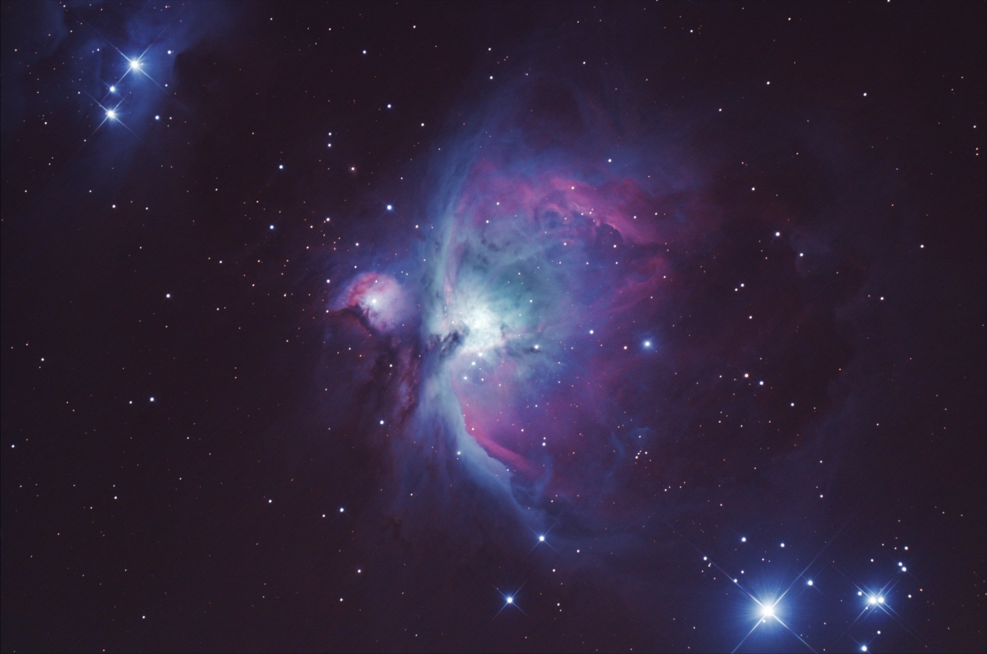 HD PC desktop wallpaper of the Orion Nebula: glowing purple-blue gas clouds and bright stars in deep space, sci-fi cosmic background.
