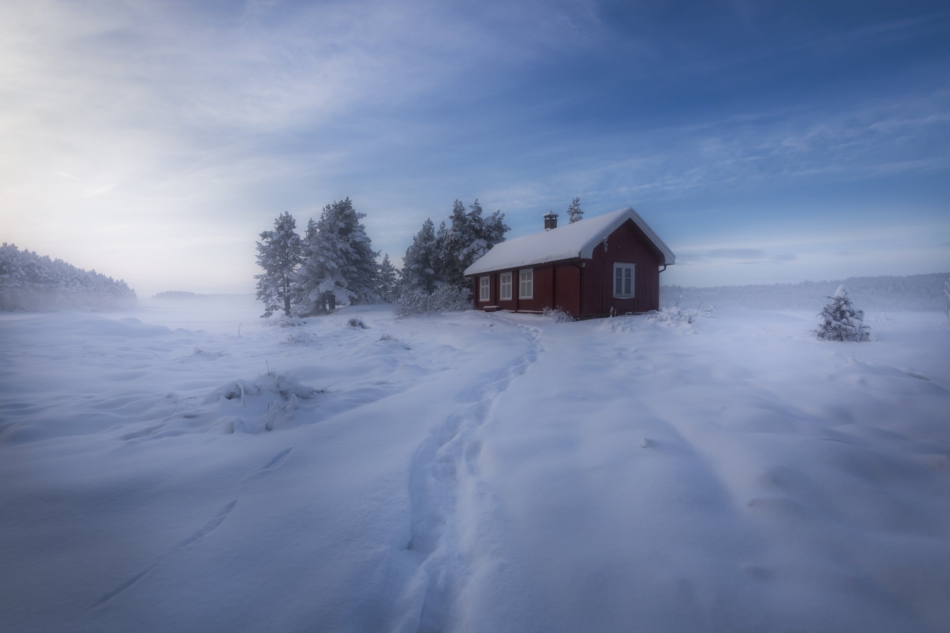 A serene winter scene with a snow-covered landscape, trees, and a house, captured in HD for a desktop wallpaper or background.