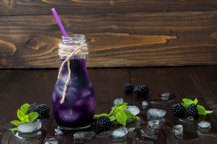 A 4K Ultra HD still life of a blackberry drink in a glass jar with a purple straw, surrounded by fresh blackberries, ice cubes, and green leaves on a dark wooden surface.