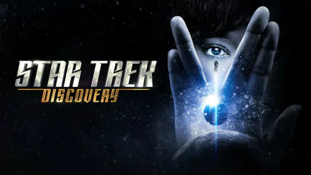 HD desktop wallpaper featuring Star Trek: Discovery with a mysterious figure peering through a Vulcan salute, against a cosmic backdrop.