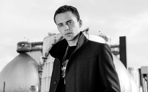 HD desktop wallpaper featuring a monochrome image of a man in a coat with industrial structures in the background, tagged with Logic.