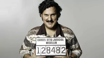 HD PC wallpaper of Pablo Escobar from the TV show Pablo Escobar, The Drug Lord, featuring his mugshot holding a prison identification placard.