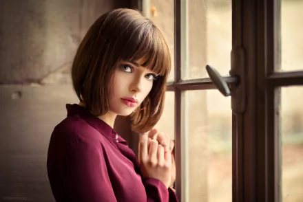 A French brunette woman with short hair and lipstick gazes thoughtfully out a window. The image, tagged with 'Marie Grippon', showcases a model and serves as an HD desktop wallpaper and background.