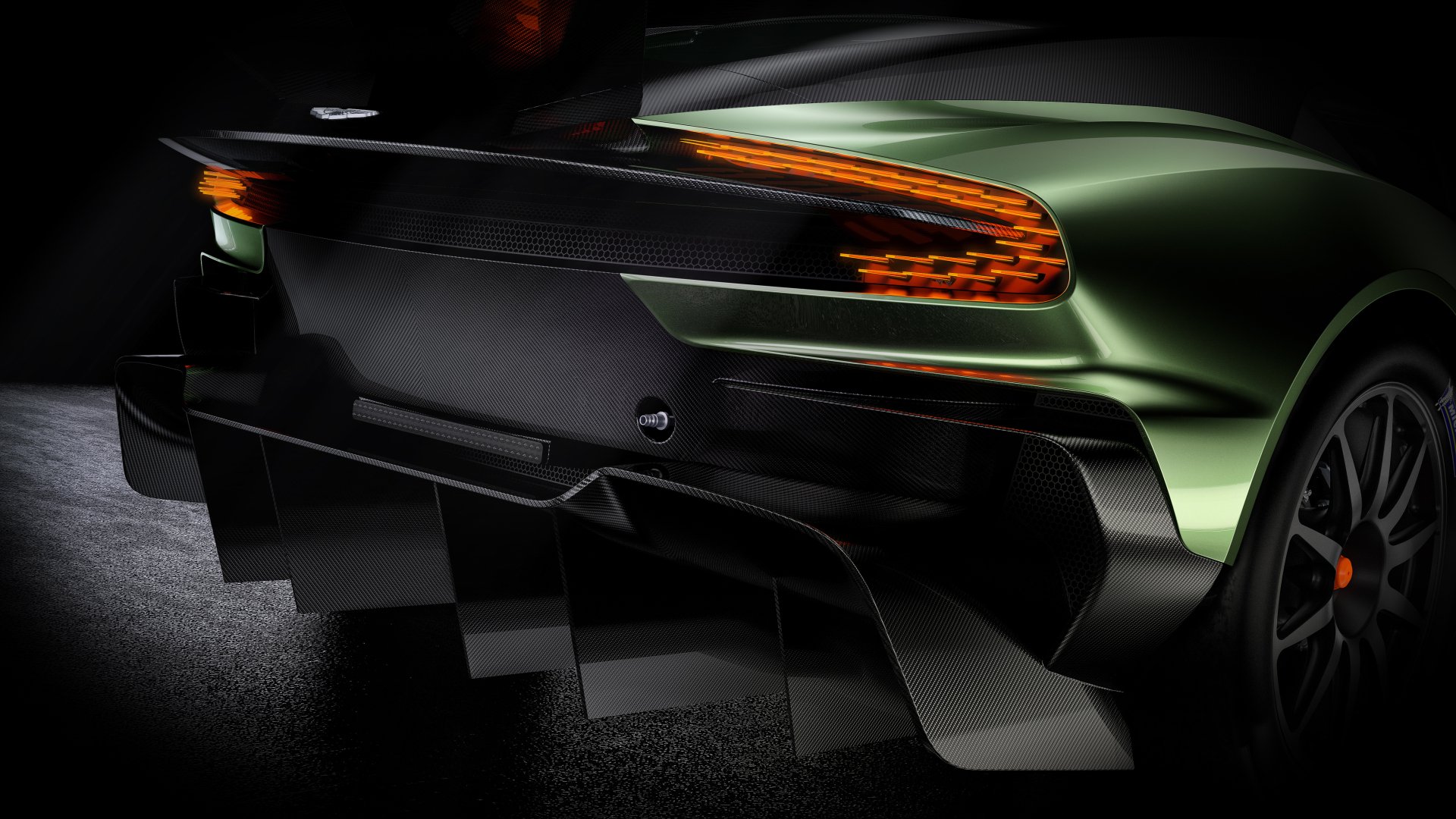 A close-up of the rear of an Aston Martin Vulcan hypercar race car, showcasing its sleek design and aggressive aerodynamic features in 4K Ultra HD quality.