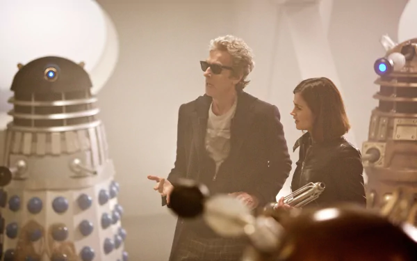 4K Ultra HD Doctor Who wallpaper featuring Peter Capaldi as the 12th Doctor and Jenna Coleman as Clara Oswald surrounded by Daleks from the TV show.