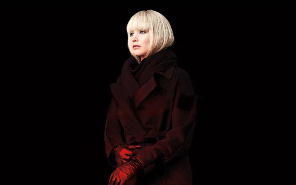 HD desktop wallpaper featuring blonde Jennifer Lawrence in a dark coat and red gloves from the movie Red Sparrow against a black background.