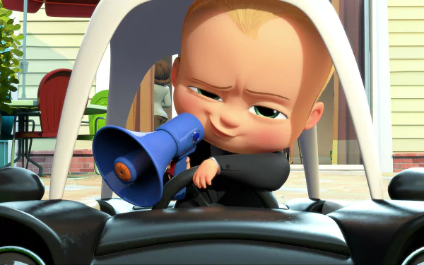 HD desktop wallpaper featuring Theodore Templeton, also known as The Boss Baby, from the movie The Boss Baby, sitting in a toy car and speaking into a blue megaphone.