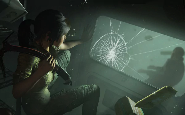 Lara Croft from Shadow of the Tomb Raider crouches inside a dimly lit, cracked-glass vehicle, holding a flashlight in this 4K Ultra HD video game desktop wallpaper.