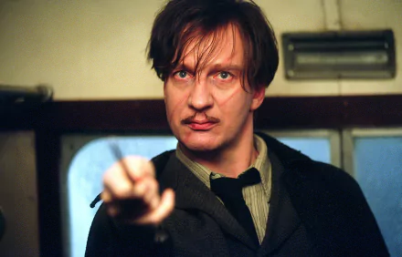 Remus Lupin from the Harry Potter and the Prisoner of Azkaban movie, pointing his wand in a moody HD PC desktop wallpaper and background.