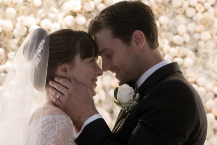 HD wallpaper from Fifty Shades Freed featuring a bride and groom in a romantic close-up embrace.