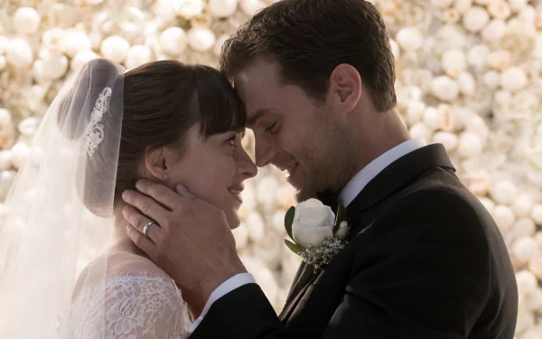 HD wallpaper from Fifty Shades Freed featuring a bride and groom in a romantic close-up embrace.