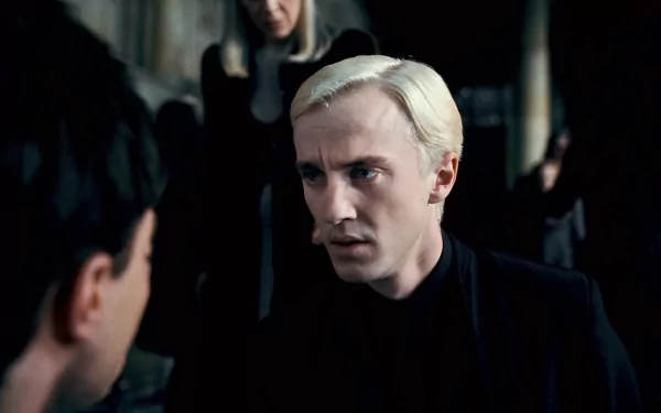 HD PC desktop wallpaper of Draco Malfoy from Harry Potter and the Deathly Hallows: Part 1 — pale, slicked-back blond hair, dark robes, intense stare.