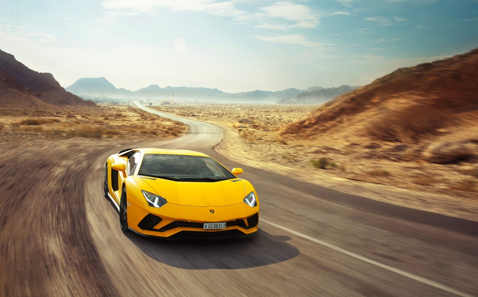 Yellow Lamborghini Aventador S supercar racing along a winding desert road with motion blur, HD PC desktop wallpaper background