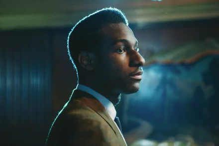 HD desktop wallpaper featuring a profile view of Leon Bridges in a dimly lit room, exuding a serene atmosphere.