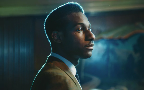 HD desktop wallpaper featuring a profile view of Leon Bridges in a dimly lit room, exuding a serene atmosphere.