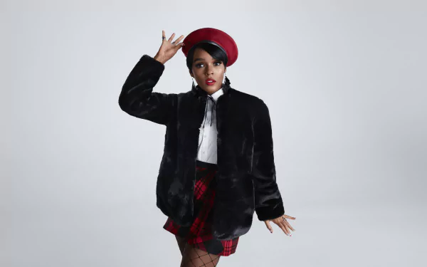 HD wallpaper featuring a stylish person in a red hat and black jacket, posing against a grey background.