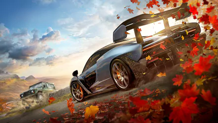 HD wallpaper featuring a dynamic scene from Forza Horizon 4 with a sports car and an off-road vehicle on a dirt road, surrounded by falling autumn leaves.
