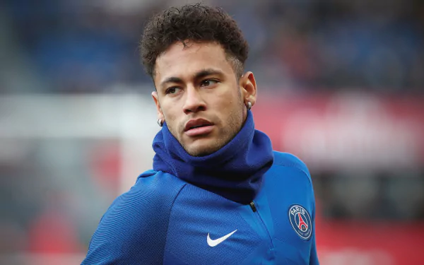 HD desktop wallpaper featuring Brazilian soccer star Neymar in a blue Paris Saint-Germain training jacket, captured in a sports setting.