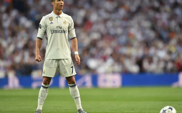 HD desktop wallpaper featuring Portuguese soccer star Cristiano Ronaldo on the field, wearing his white Real Madrid uniform during a match.