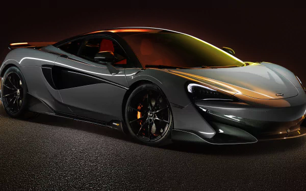 Silver McLaren 600LT supercar showcased in striking detail against a dark background, captured in 8K Ultra HD for a sharp PC desktop wallpaper.