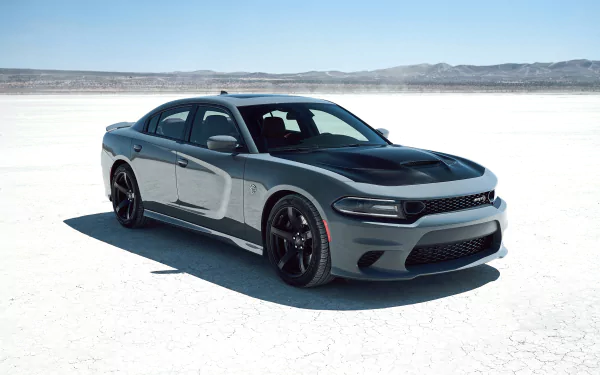 Silver Dodge Charger SRT muscle car parked on a white salt flat under a clear blue sky, showcased as a high-definition PC desktop wallpaper.
