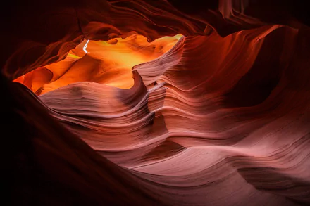 HD PC desktop wallpaper showcasing the smooth, flowing sandstone formations and warm glowing light of Antelope Canyon in a striking nature landscape.
