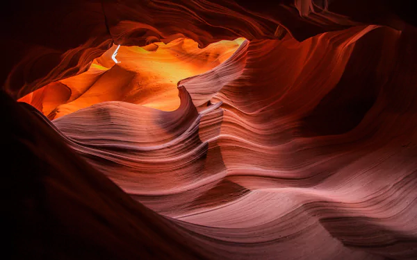 HD PC desktop wallpaper showcasing the smooth, flowing sandstone formations and warm glowing light of Antelope Canyon in a striking nature landscape.