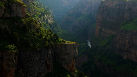 HD desktop wallpaper of a lush forested cliff landscape in Brazil, with massive mountains and a river carving through the deep valley below.