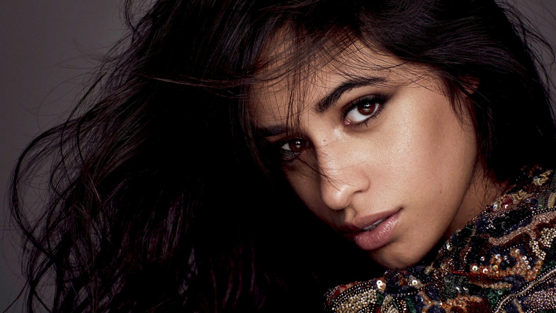 Close-up HD portrait of a Latina brunette singer with brown eyes, featuring Camila Cabello as a PC desktop wallpaper and background.