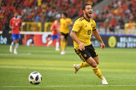 HD desktop wallpaper featuring a dynamic action shot of a soccer player in a yellow kit with the number 10, playing on the field.