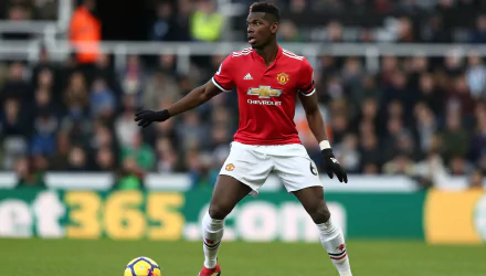 Paul Pogba in Manchester United kit on the pitch, focused on the game—a HD desktop wallpaper and background.