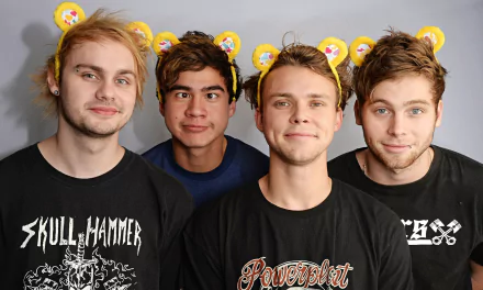 HD desktop wallpaper featuring the band 5 Seconds Of Summer posing together with a playful background.