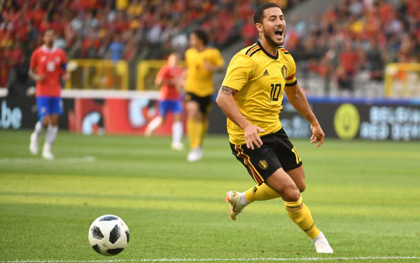 HD desktop wallpaper featuring a dynamic action shot of a soccer player in a yellow kit with the number 10, playing on the field.