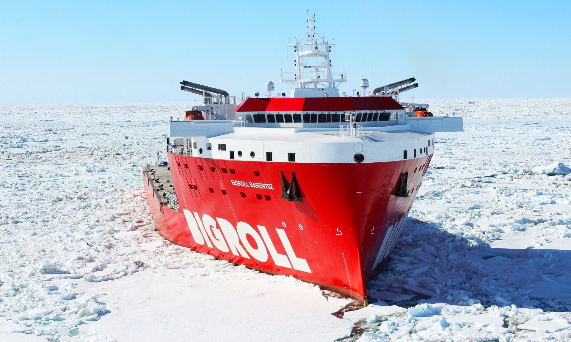 HD desktop wallpaper featuring the Bigroll Barentsz, a red ship navigating through Arctic sea ice.