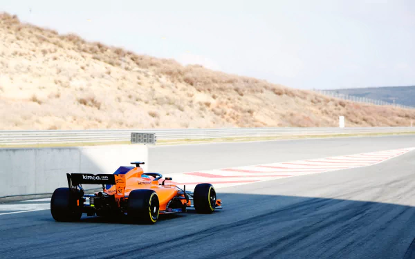 McLaren MCL33 F1 car racing on a sunlit track, showcasing vibrant orange and blue colors in a 4K Ultra HD PC desktop wallpaper and background.