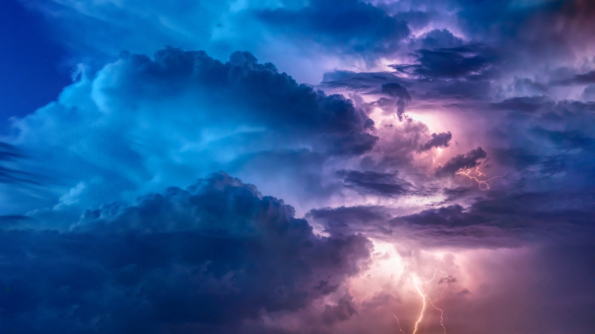 HD desktop wallpaper featuring a dramatic storm with dark clouds, vivid lightning, and colorful skies, showcasing the captivating beauty and power of nature.